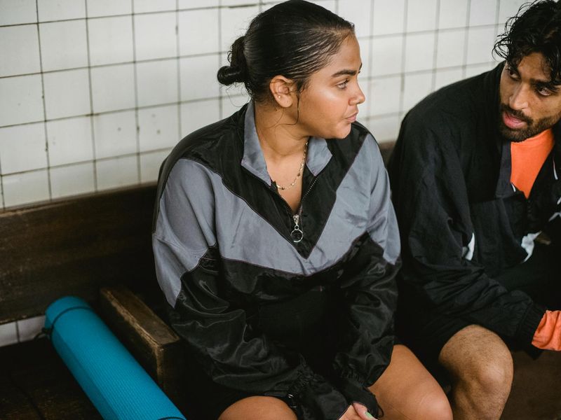 Person smiling after a workout, looking refreshed and energetic.